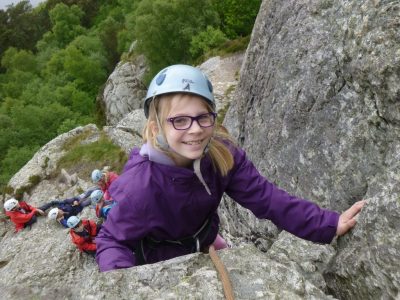 school rock climbing on an outdoor activity course
